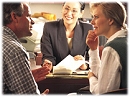 Couple speaking with escrow officer